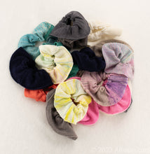 Load image into Gallery viewer, Gentle on Hair, Strong in Hold: Wrap your hair in the softness of cashmere without compromising on strength.  California Craftsmanship: Ethically made in California, our scrunchies feature sustainable cashmere from Mongolian goat herders.  Hand-Dyed Yarn: Choose from a variety of hand-dyed colors, making it a stylish and personalized gift, all the various colors are displayed
